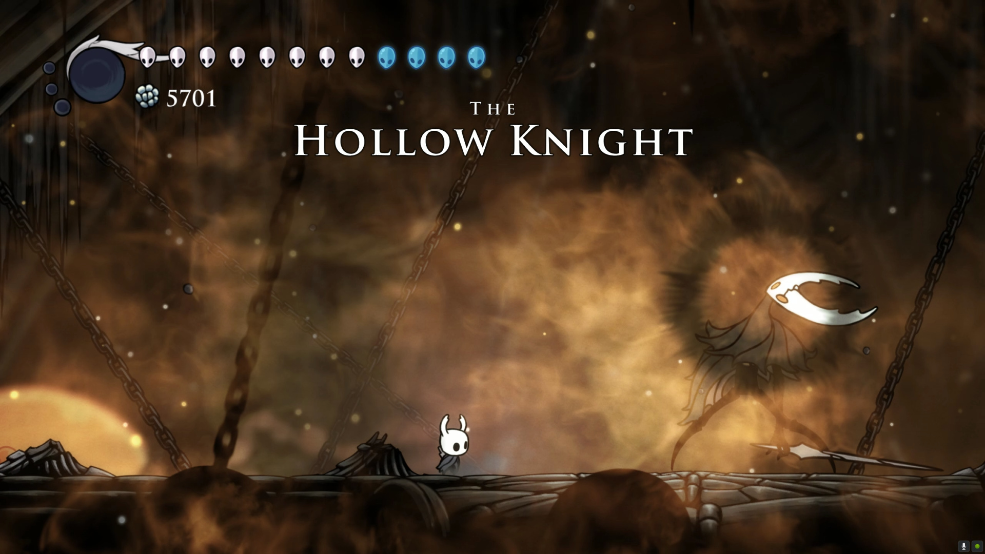 Hollow Knight boss intro for "The Hollow Knight" — HUD shows mask icons (HP), 4 blue Soul orbs and 7 white Soul vials, geo counter 5701, the Knight tiny in the foreground vs. the giant boss silhouette at right