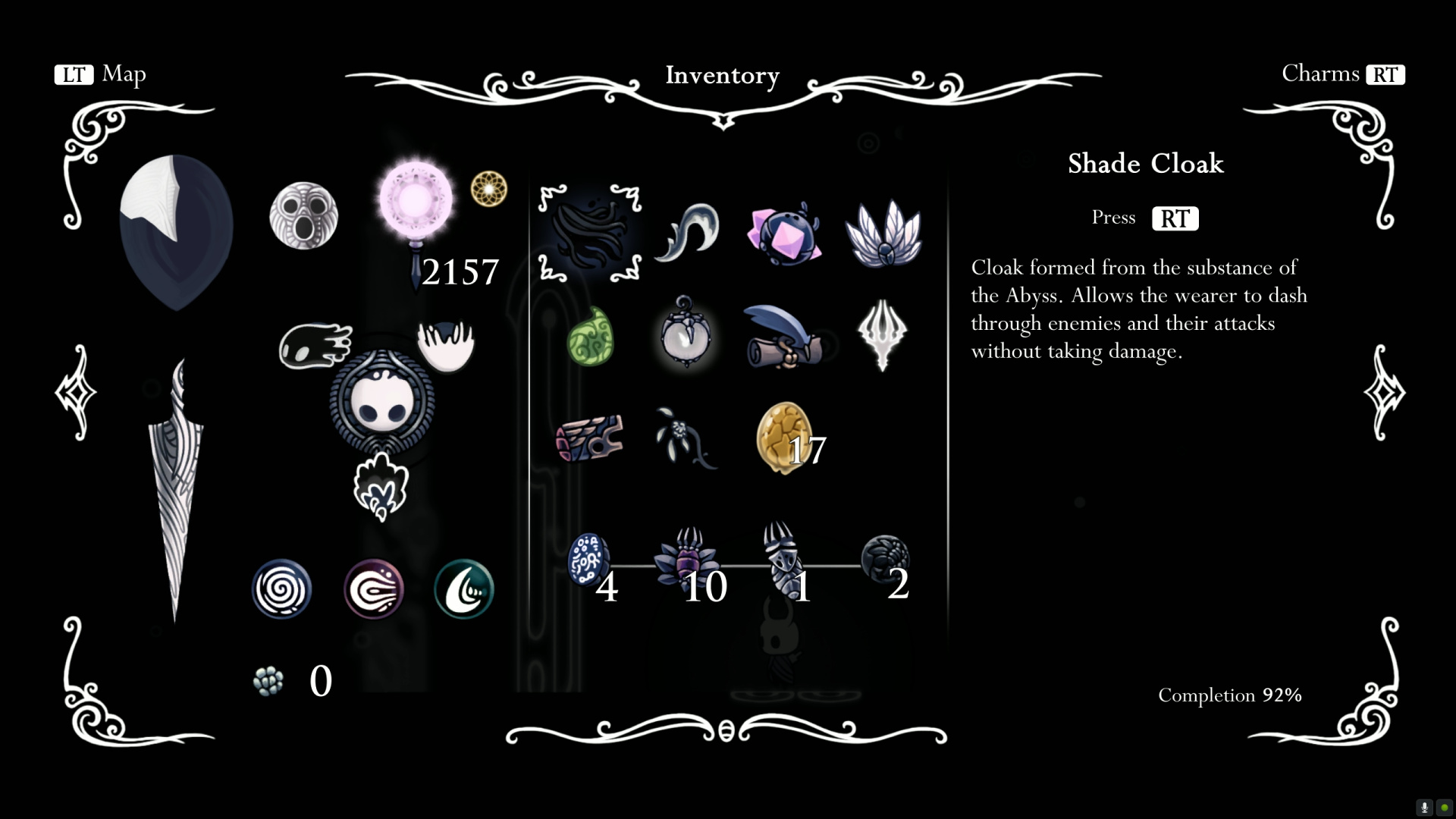 Hollow Knight inventory screen — Geo counter (2157), Pale Ore (17), spell row (Vengeful Spirit, Shade Soul-style, Howling Wraiths), Mask Shards icon, Vessel Fragments, Shade Cloak description on the right reading "Cloak formed from the substance of the Abyss. Allows the wearer to dash through enemies and their attacks without taking damage"