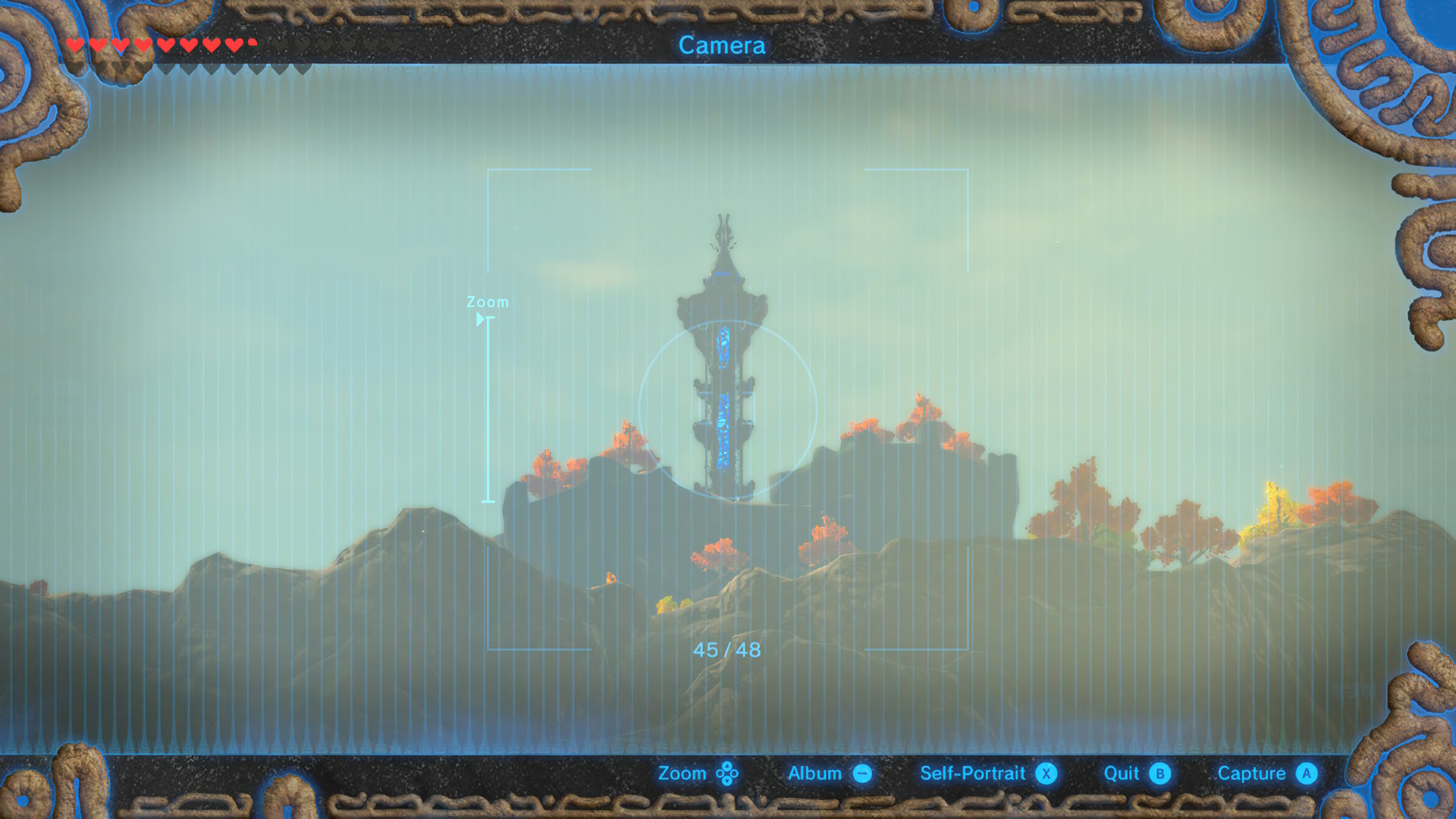 The Camera Mode viewfinder framing a Sheikah Tower in the distance — "45/48" photos taken, framing brackets visible. Bottom controls: Zoom / Album / Self-Portrait / Quit / Capture