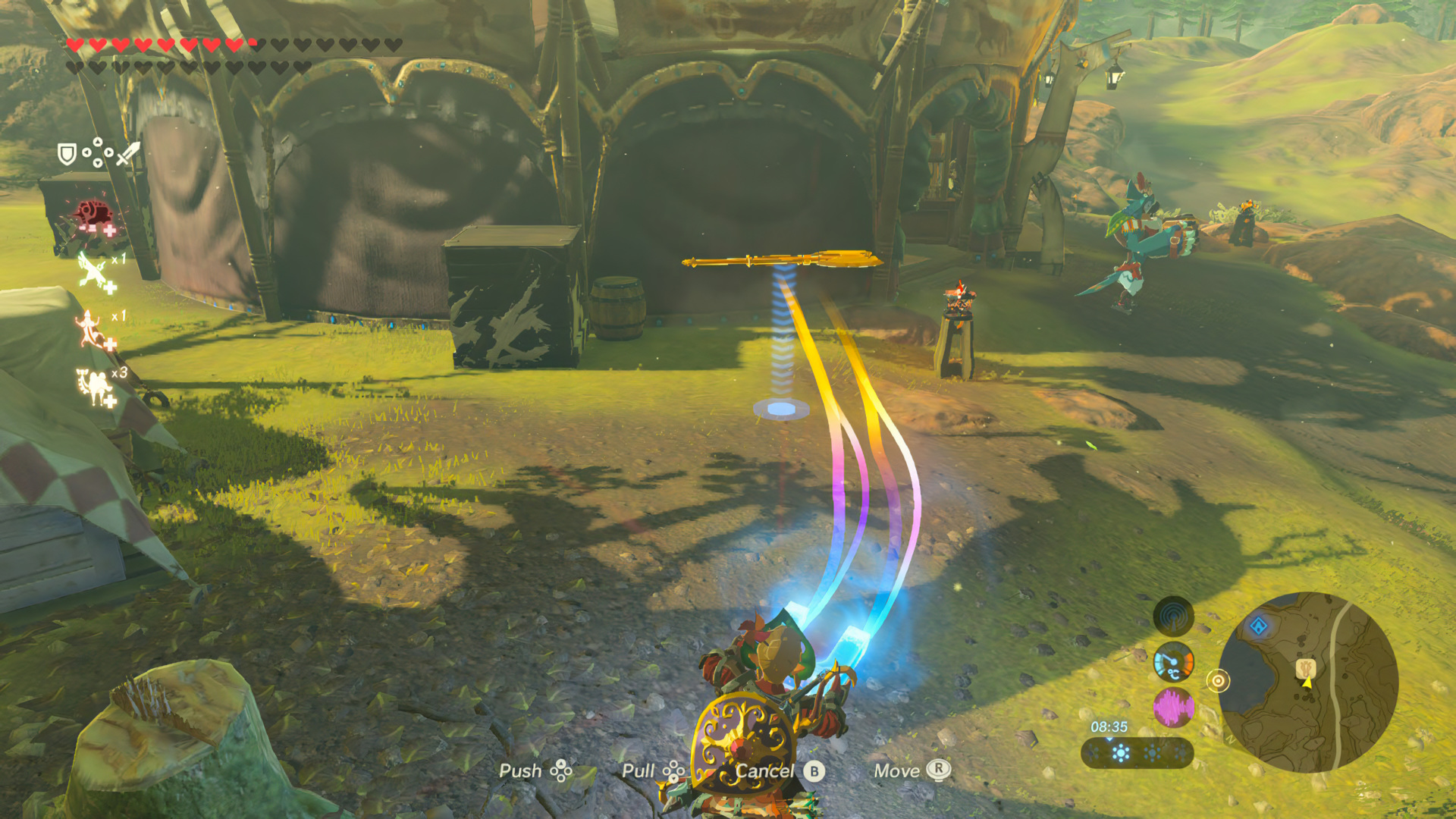Magnesis in action — Link aims the rune at a metallic spear glowing yellow + a metallic box mid-air, in a Yiga Clan stronghold. Prompts at bottom: Push / Pull / Cancel / Move