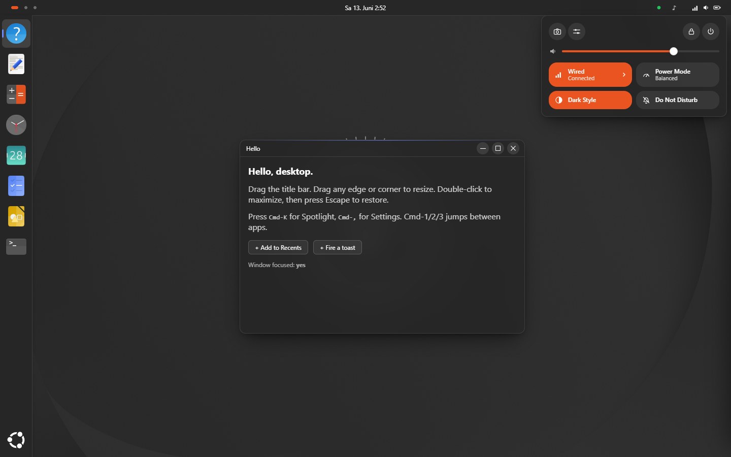 The Ubuntu theme: a dark GNOME-style desktop with a top bar, a centered clock, a left dock flush to the edge, a window with round symbolic controls, and the Quick Settings popover showing a volume slider and Wired, Power Mode, Dark Style, and Do Not Disturb tiles